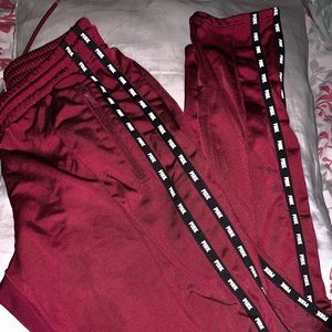Pink track pants but color red
